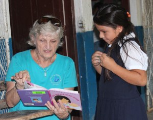 Jane Mirandette reading to a student at a rural school