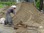 A young woman mixing cement for resurfacing the current library